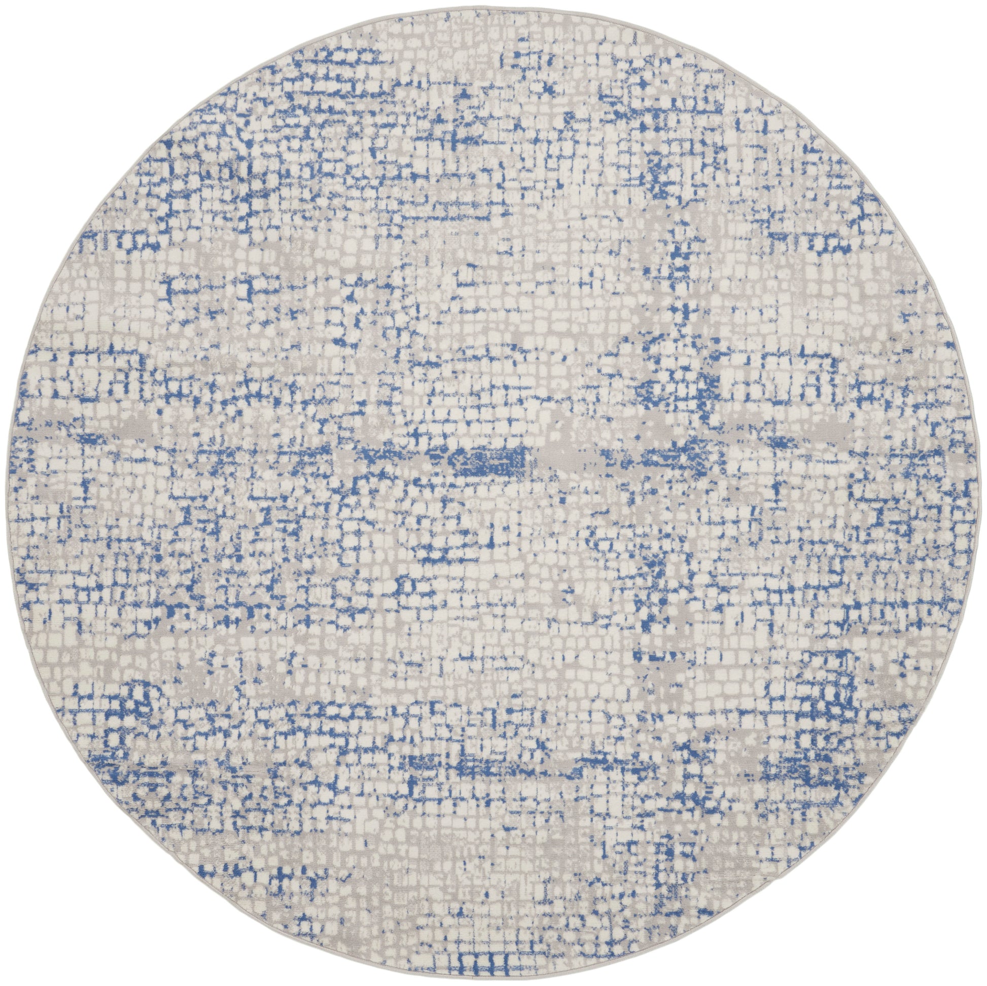 Round beige rug featuring a blue distressed abstract pattern and soft woven texture for a modern, casual look.