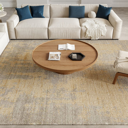Muted yellow-gray rug (8' x 10') on the floor in a living room, with a round wooden coffee table nearby.