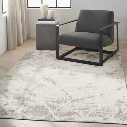 Gray rug with a light abstract pattern in a modern living room, size 5' x 7'.