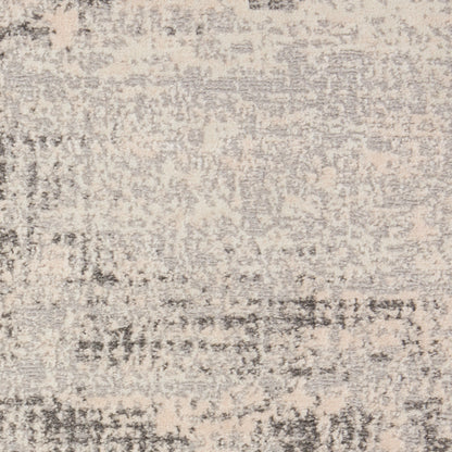 Beige and gray distressed abstract patterned area rug.