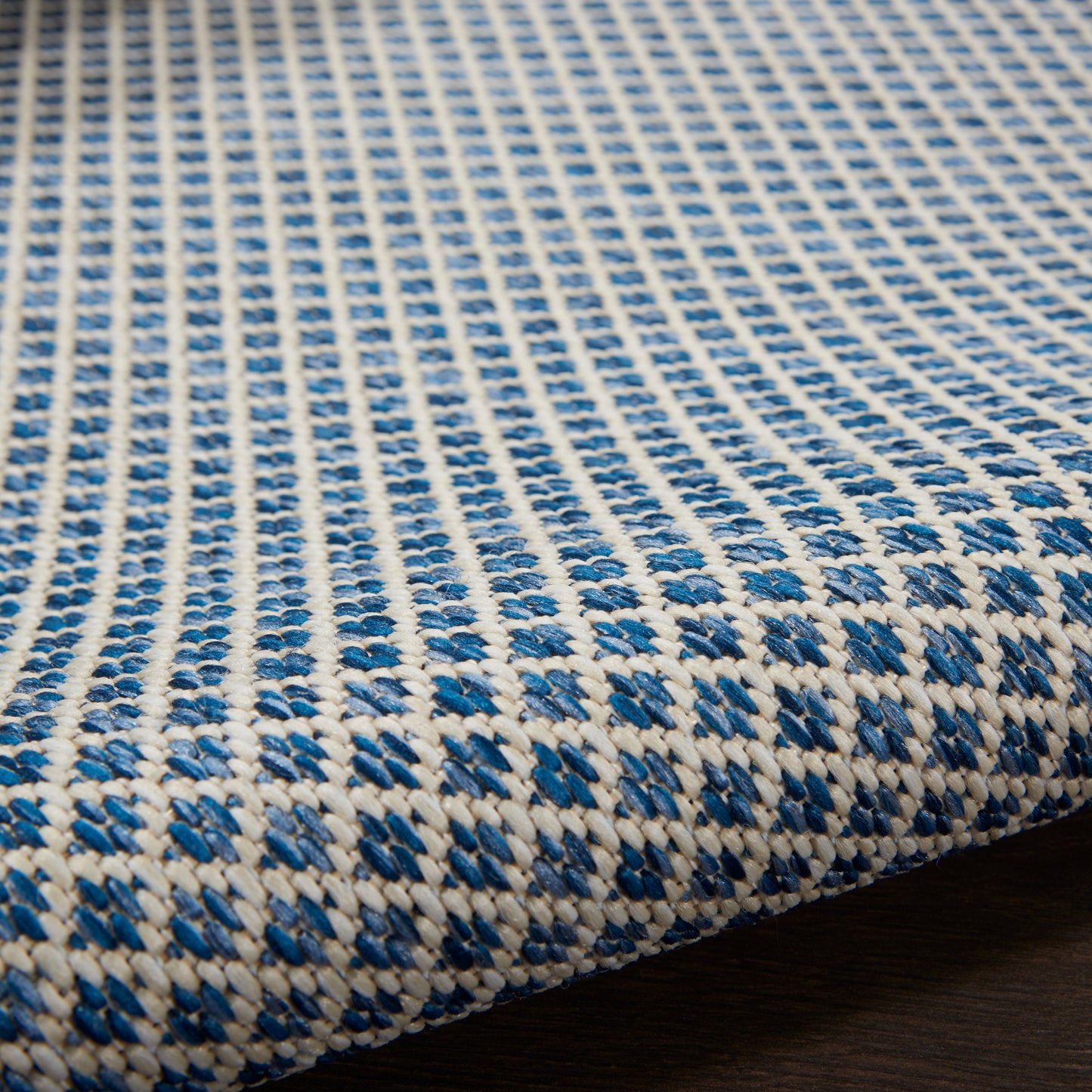 Blue and white woven rug runner with a geometric pattern and textured braided surface, 10 ft long.