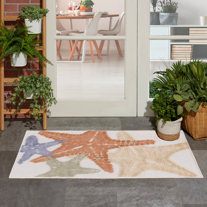 Coastal outdoor rug with multicolor starfish design - orange, blue and beige on a light background.