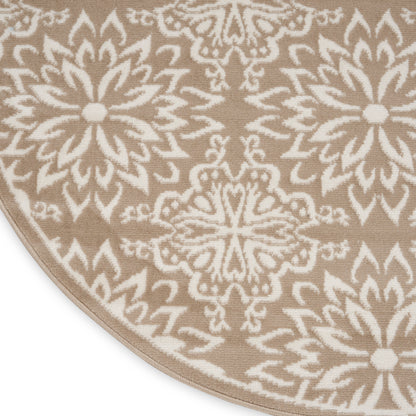 Beige rug with white mandala floral medallions; geometric pattern, curved corner visible.