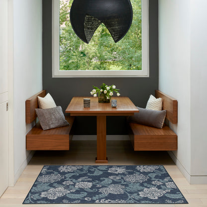 Tropical 3' x 5' rug in a dining nook with built-in benches; blue rug on the floor, a vase of white flowers, and a black pendant light.