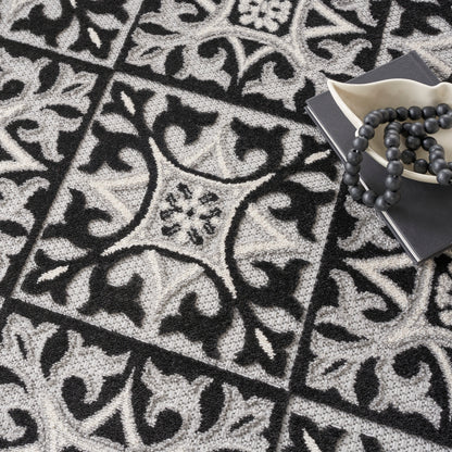 Gray and black ornate patterned round rug with tile motifs (8' round).