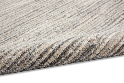 Neutral striped area rug in beige, taupe and gray; textured soft pile with a rolled edge.
