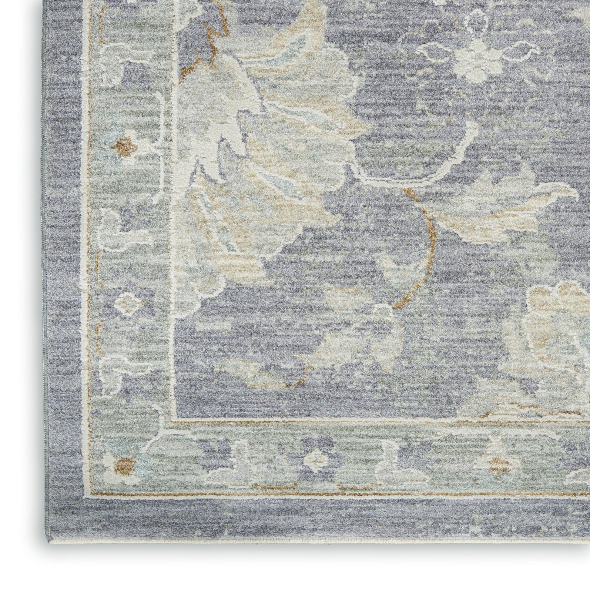 Muted blue-gray rug with cream and sage floral border, vintage damask pattern, soft textured pile.