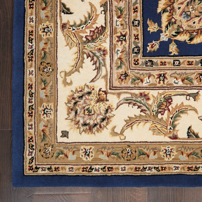 Corner view of an ornate Persian-style rug with cream field, blue border, and gold floral accents for living room decor.