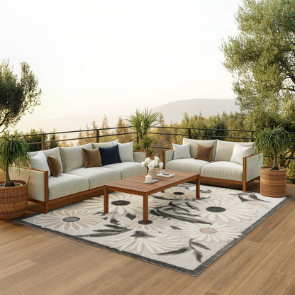 Contemporary 7' x 10' floral rug on a deck with outdoor furniture around it.