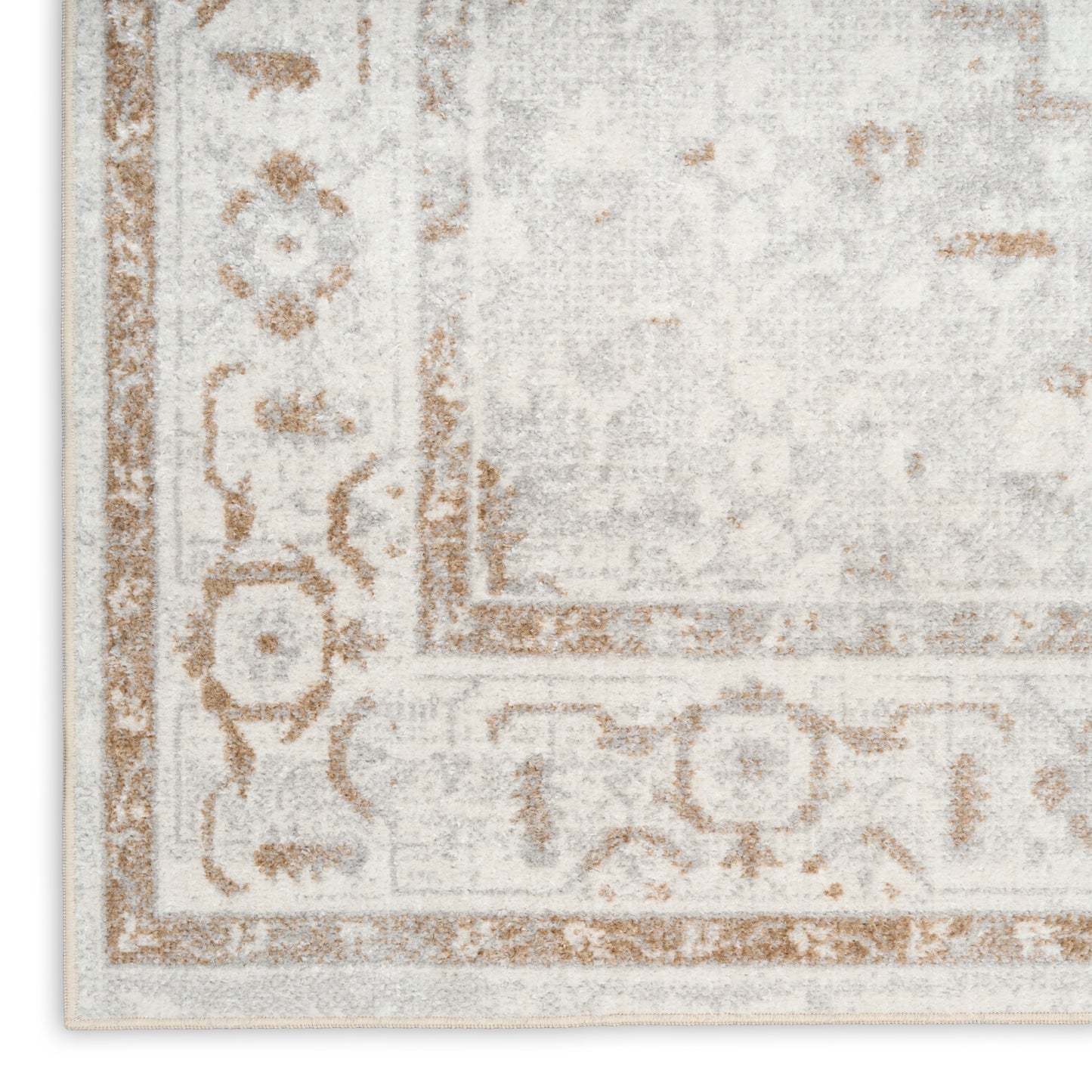 Distressed ivory and beige oriental rug with tan scroll border and faded floral pattern.