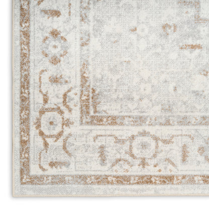 Distressed ivory and beige oriental rug with tan scroll border and faded floral pattern.