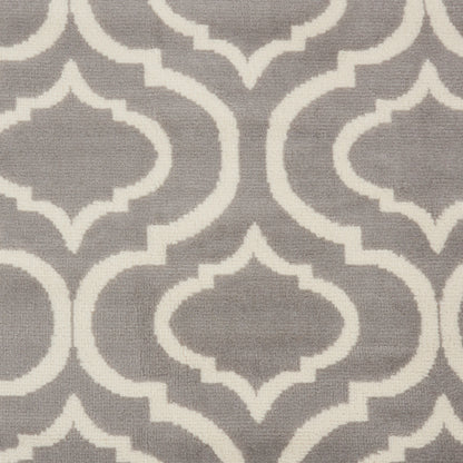 Grey rug with white trellis geometric pattern; repeating quatrefoil shapes for a modern classic look, 9' x 12'.