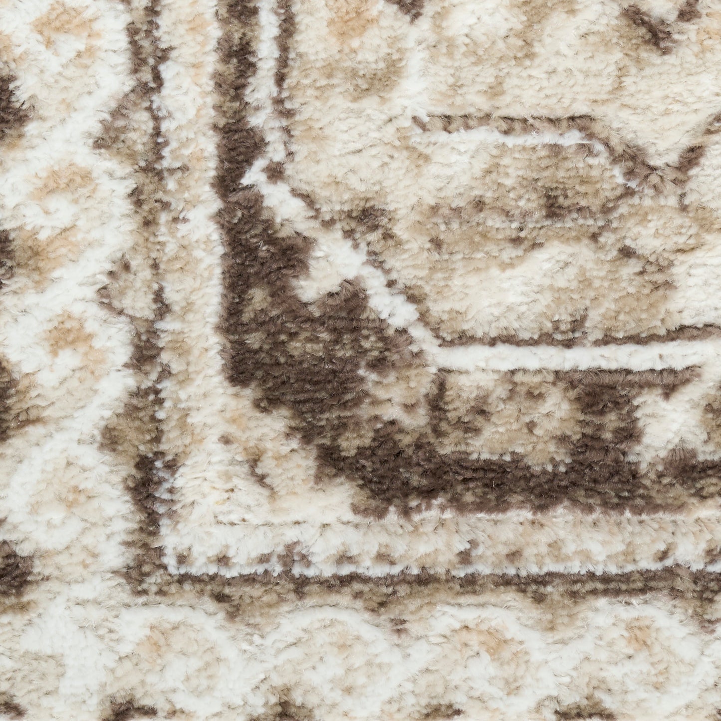 Cream, beige, and brown shag rug with a geometric border; plush pile adds cozy texture for living room decor.