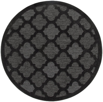 Round black rug, 5 ft diameter, with a repeating quatrefoil lattice pattern and textured surface.