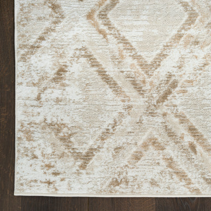 Beige geometric area rug with ivory and tan diamonds, soft textured pile on dark wood floor.