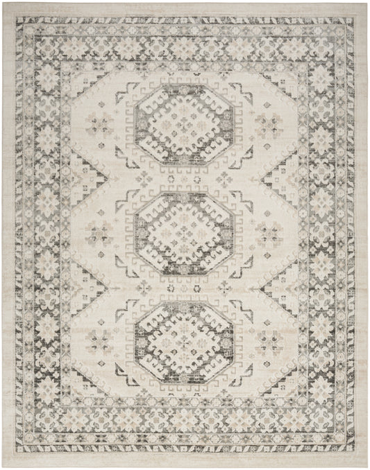Beige geometric area rug with three gray octagonal medallions, intricate border floral motifs, vintage distressed look.