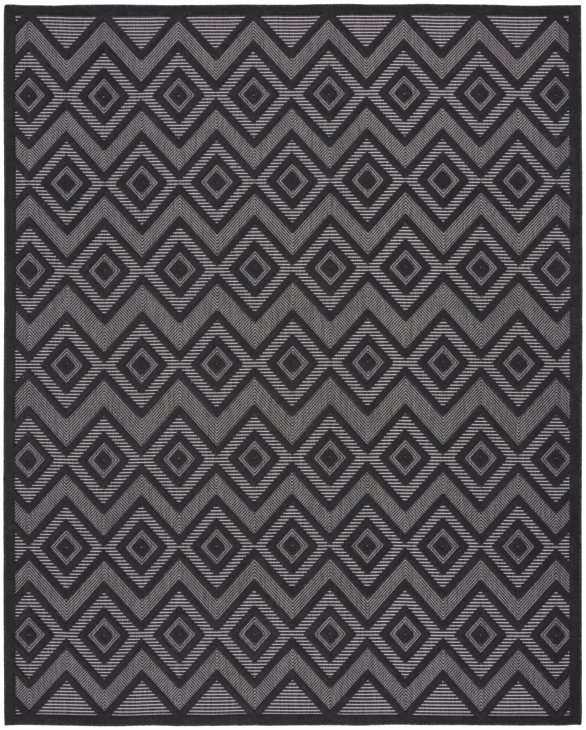 Geometric area rug with charcoal and gray diamond motifs and chevrons, bold repeating pattern.