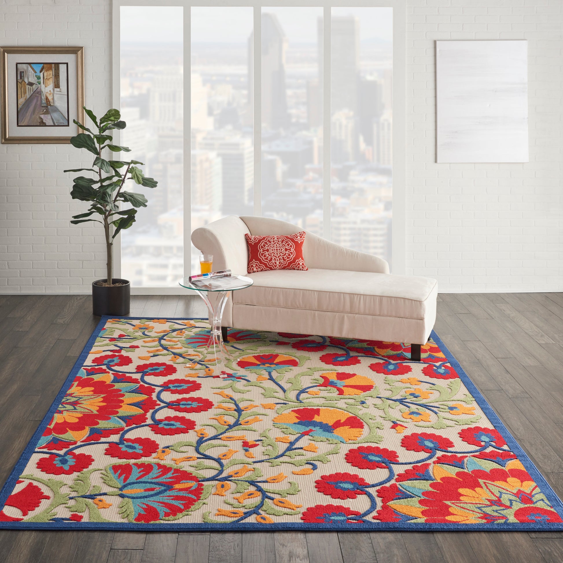 Vibrant floral area rug with red, blue, yellow hues in a modern living room; beige curved sofa and glass coffee table.