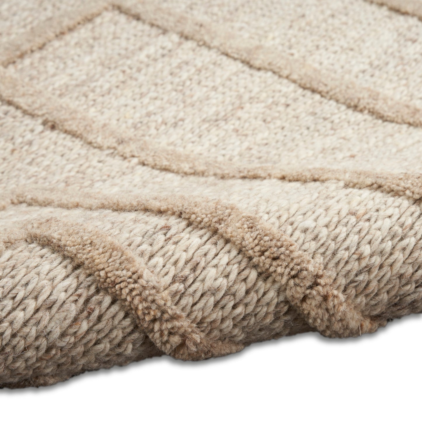 Beige chunky woven rug with thick braided edge and soft wool-like pile; cozy living room floor d??cor.