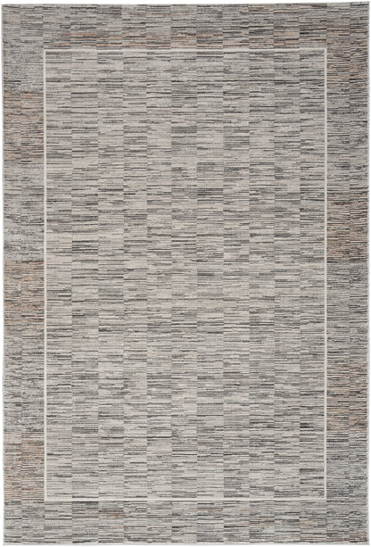 Rectangular area rug with gray and taupe stacked-strip texture and a light inner border; modern, versatile decor.