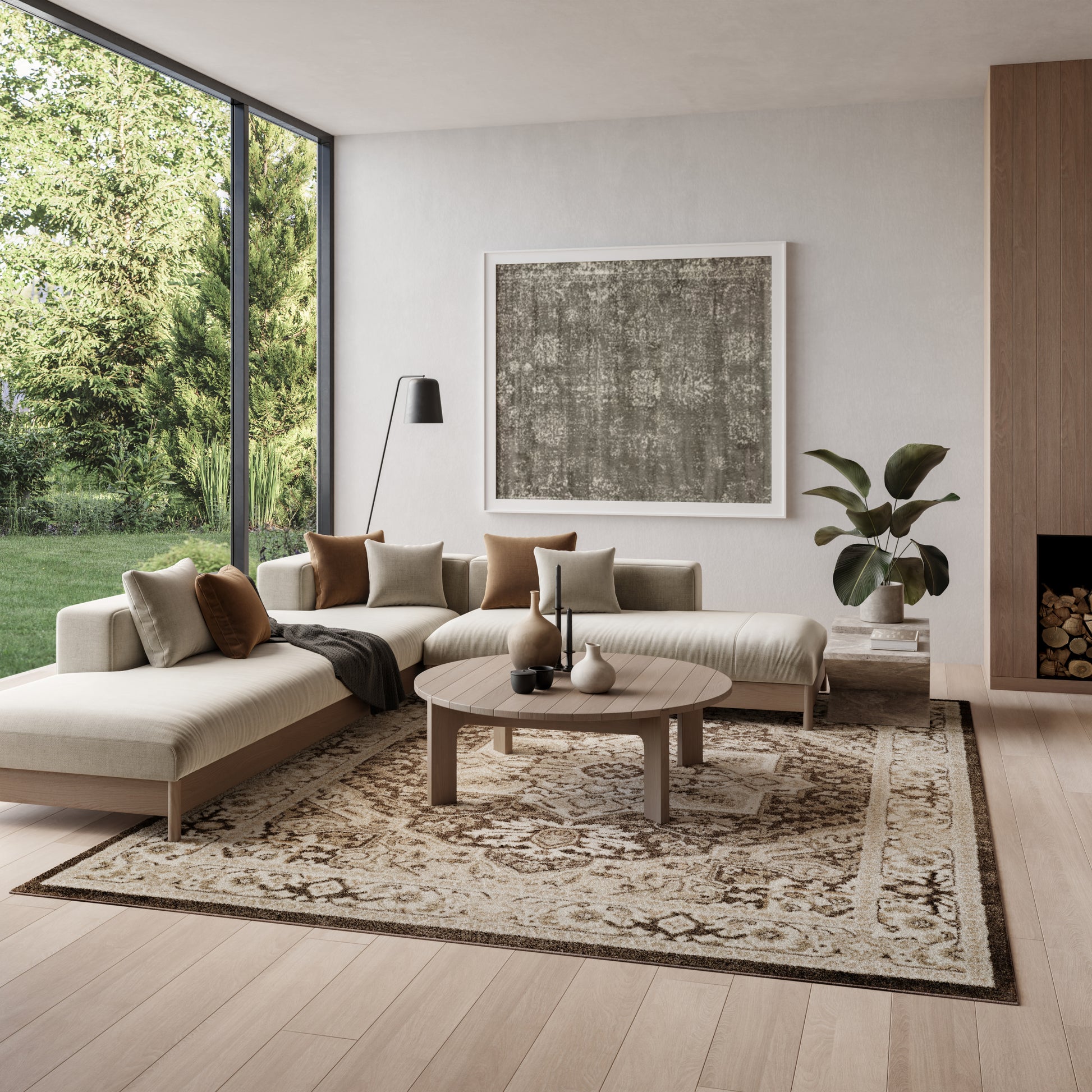 Beige patterned rug in a modern living room, with a beige sectional sofa, round wooden coffee table, plant, & large abstract art.
