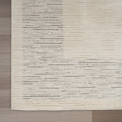 Beige woven area rug with subtle gray streaks on light wood floor; modern minimalist style.