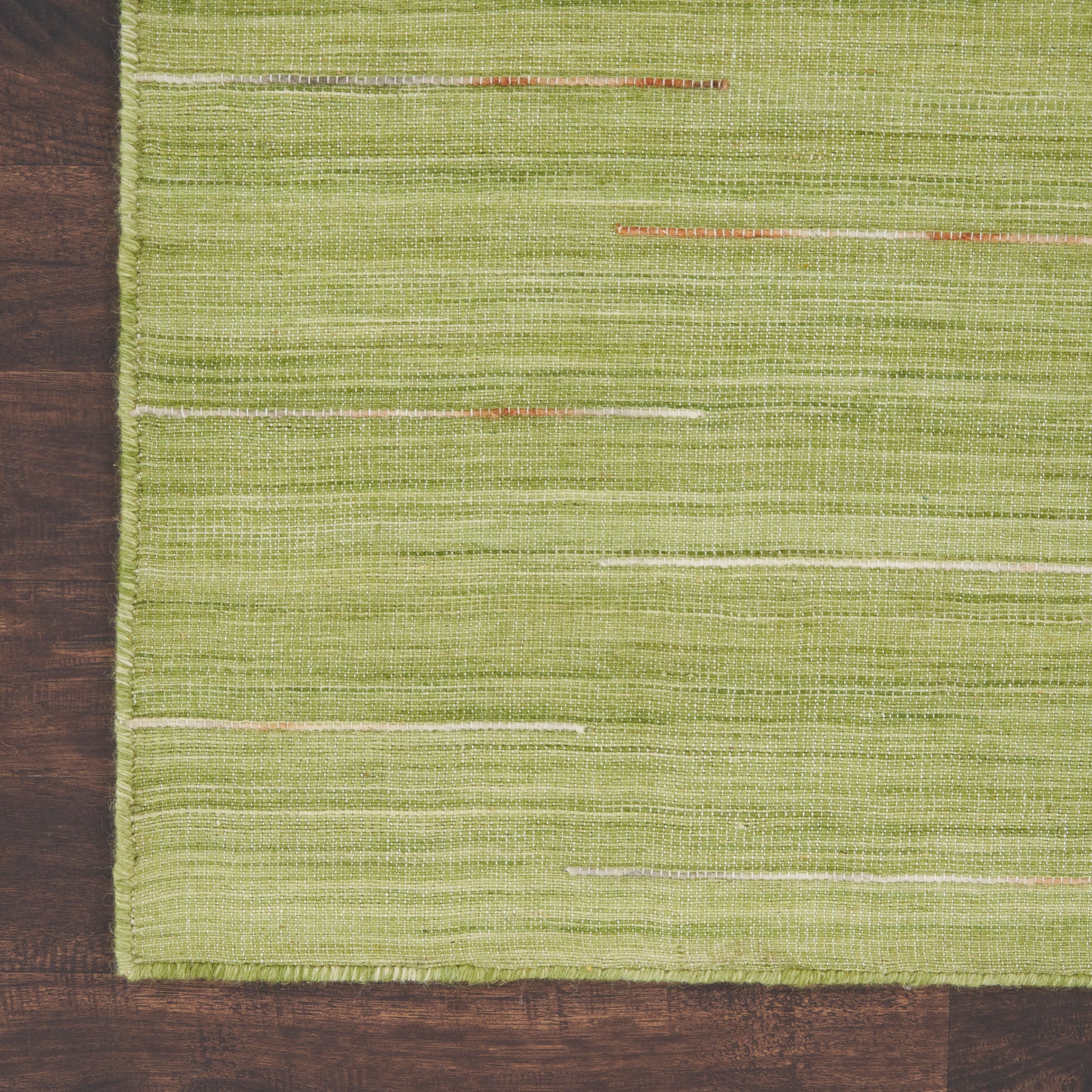 Green woven rug with horizontal cream and orange stripes on a dark wooden floor, 2' x 3'.