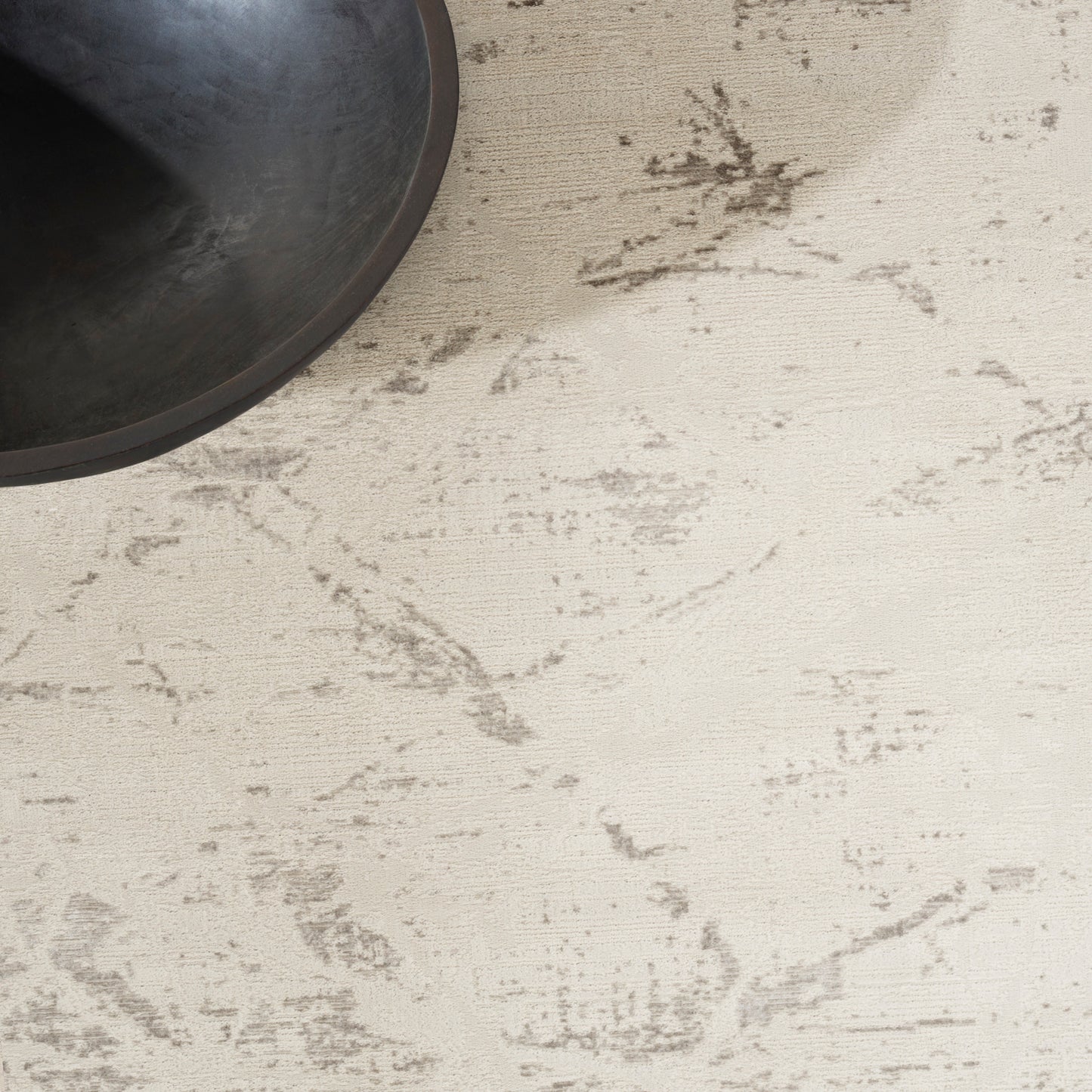 Long modern runner rug partially visible in the top-left on a light neutral surface.