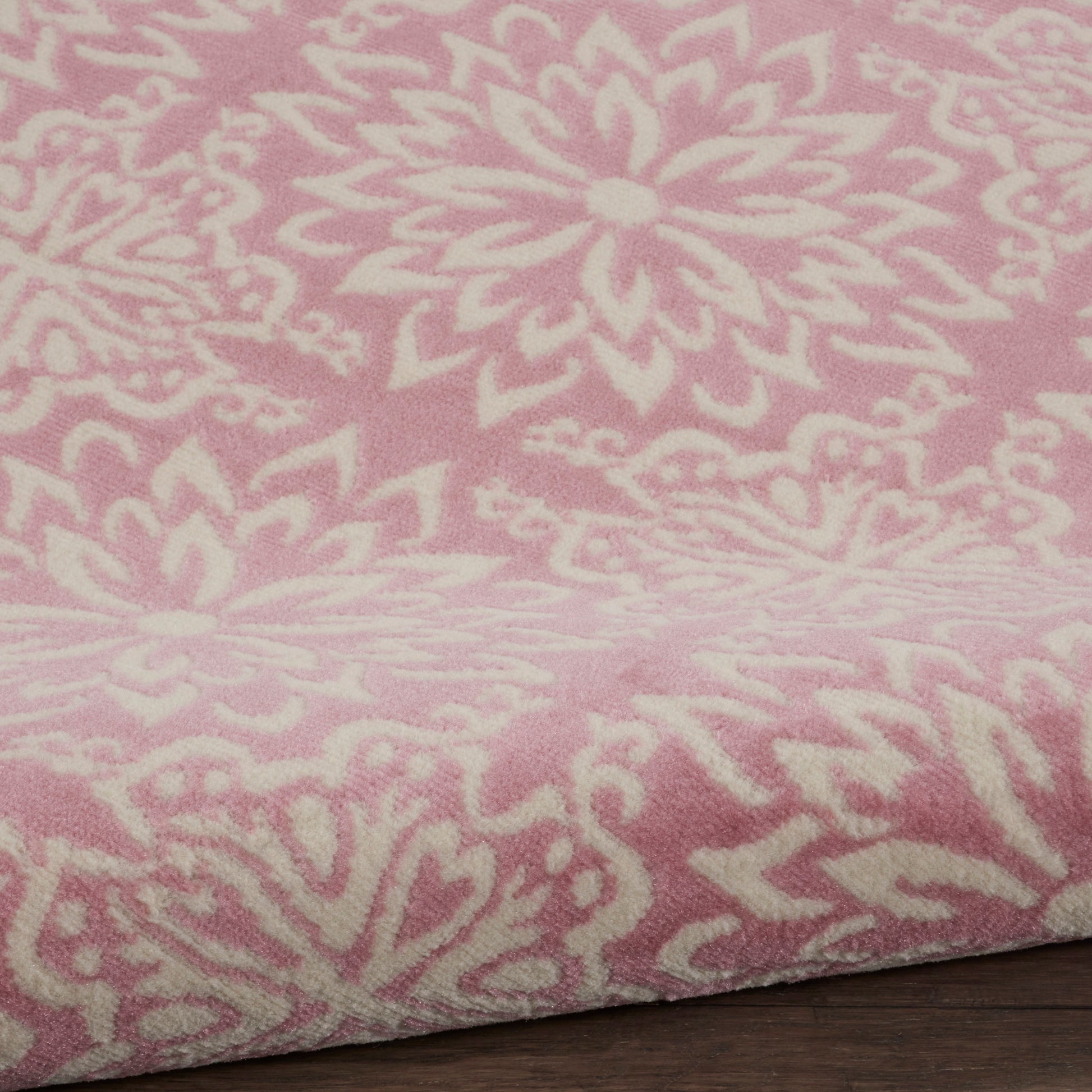 Soft pink round rug with a white mandala floral pattern, farmhouse style, 5 ft diameter.