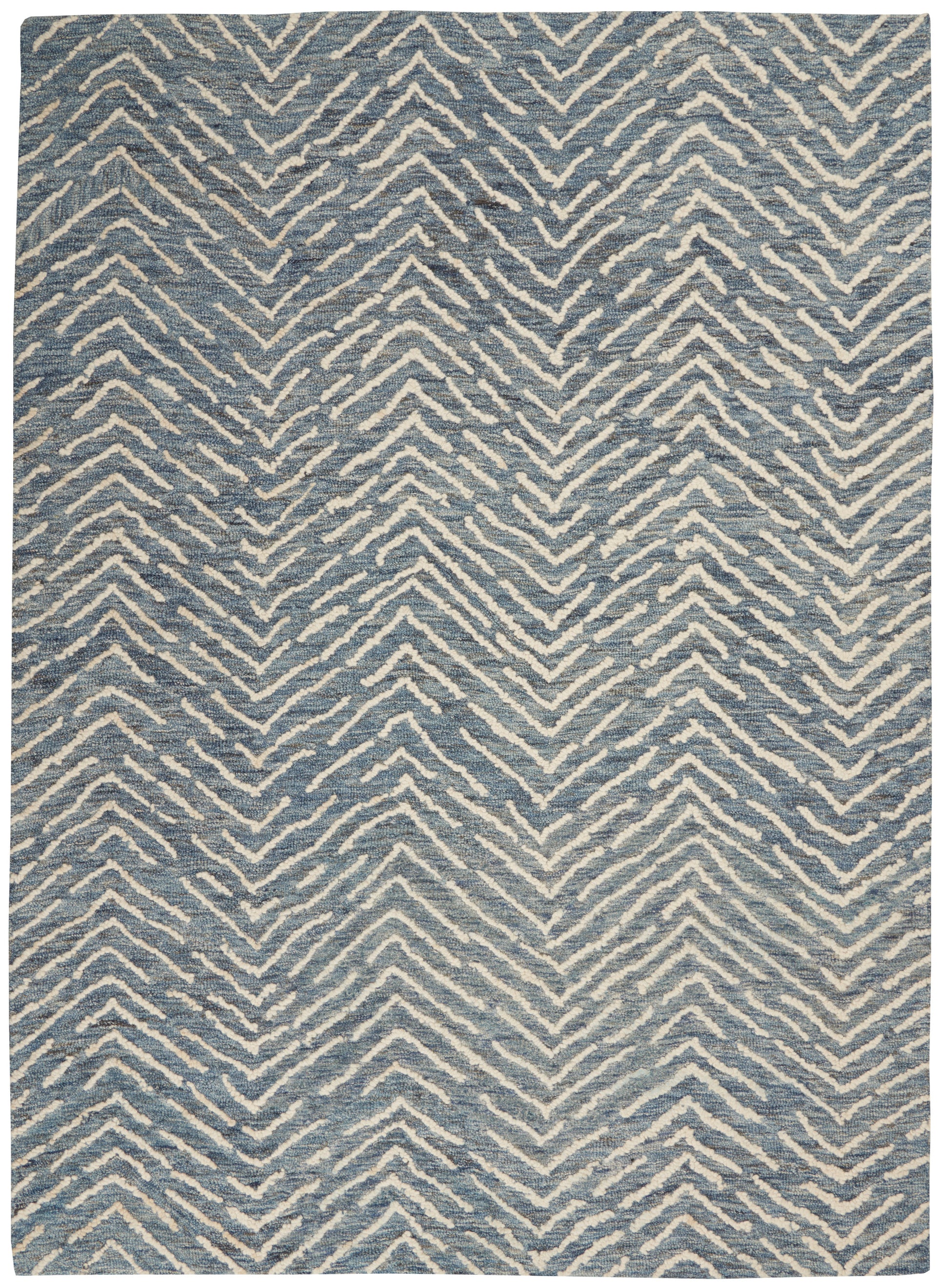 Blue rug with white zigzag chevron pattern; rectangular, woven texture, modern casual decor.