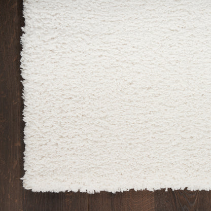 Ivory shag rug with plush pile on dark wood floor; rectangular, cozy modern home decor.