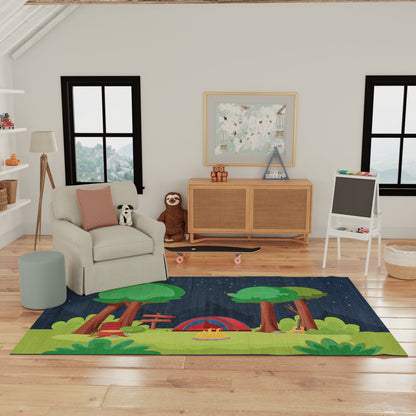 Kids' forest scene area rug with trees, red tent and campfire on a blue night sky, green grass accents.