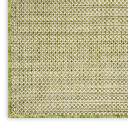 Green and white woven textile with tiny repeating quatrefoil motif; square placemat with pale green border.