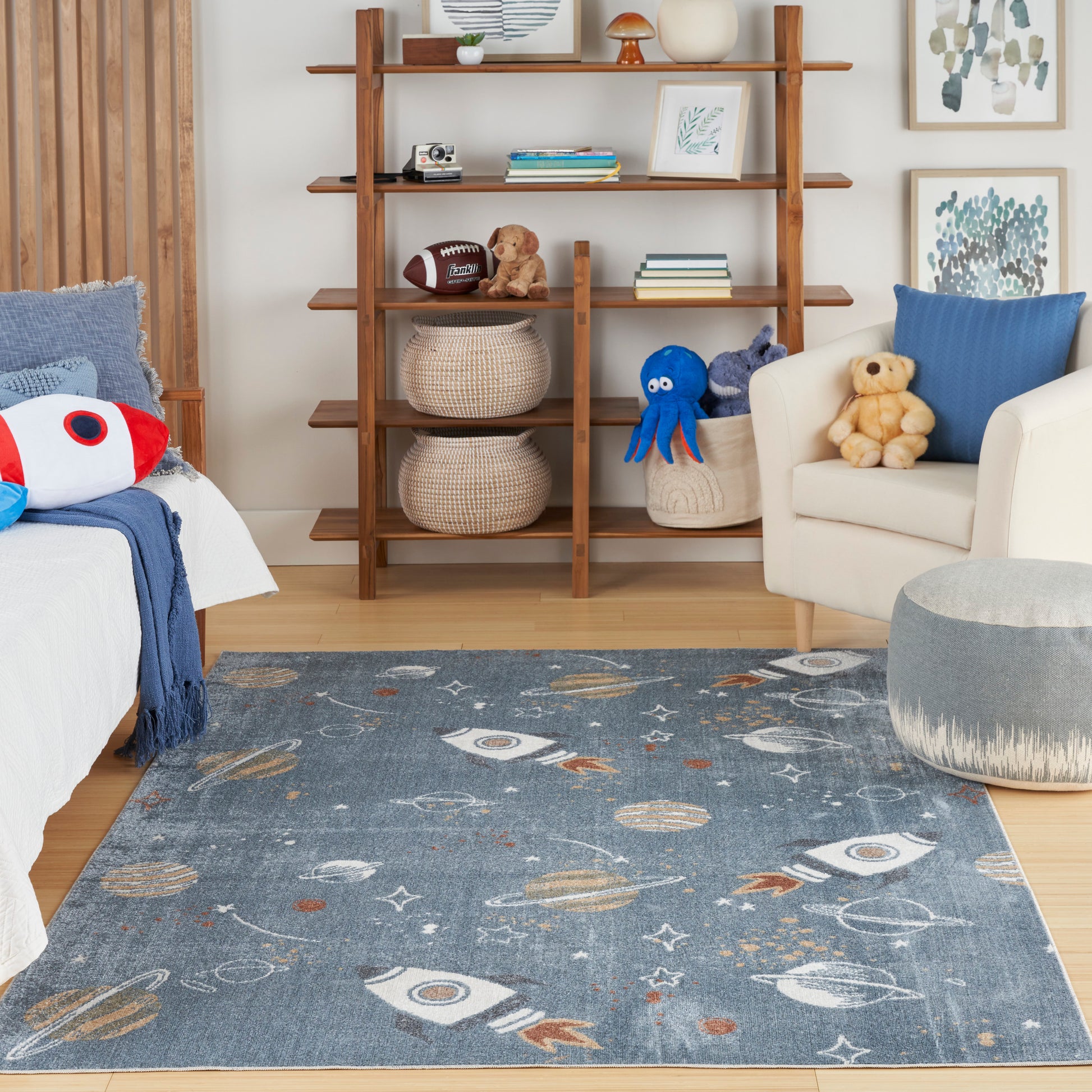 Wooden ladder bookshelf in a cozy kids' room; baskets and books, plush toys on the sofa; blue space-rocket rug on light wood floor.