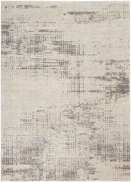 Beige abstract rug with gray distressed patches, neutral tones and soft texture.