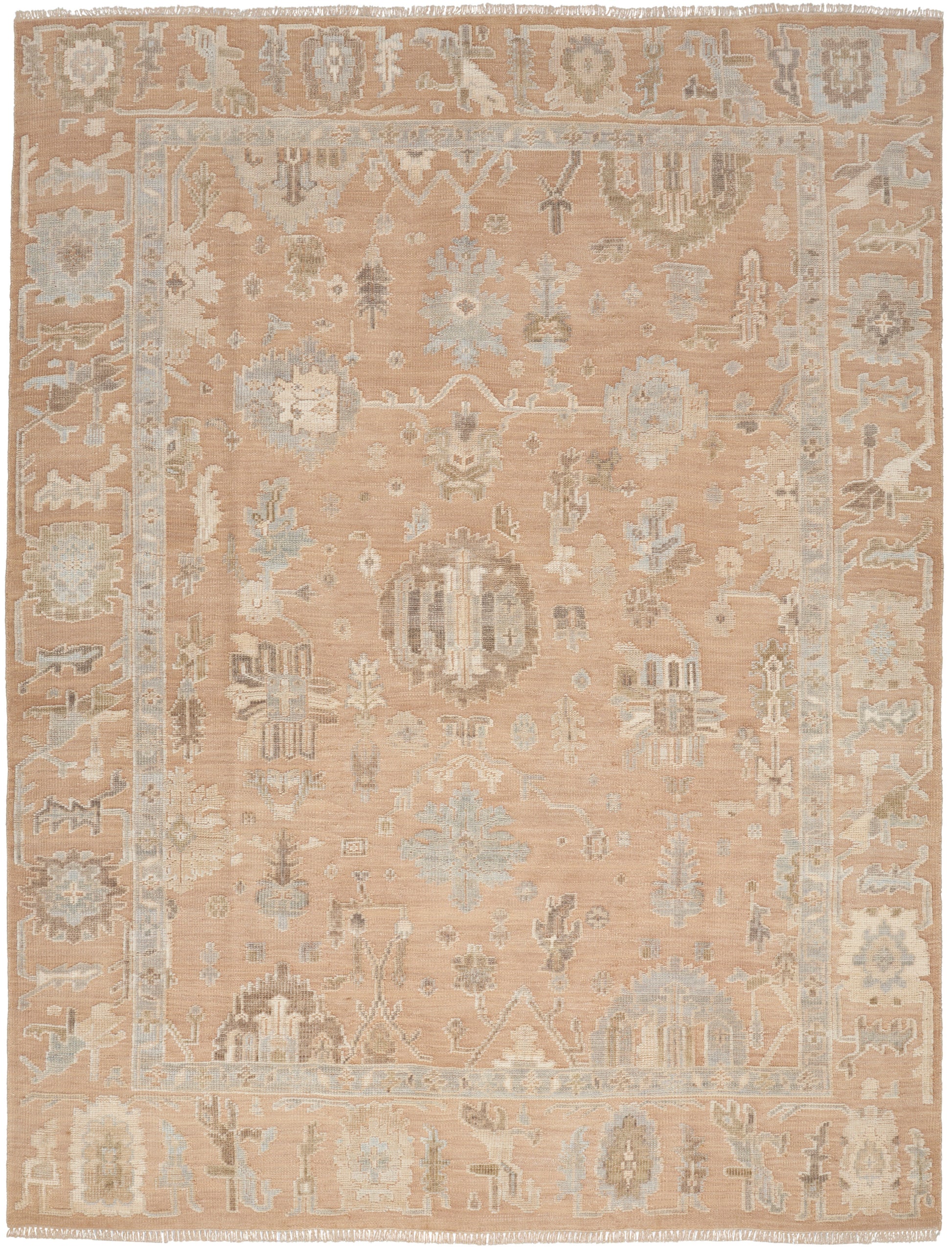 Soft peach rug with muted blue and ivory floral motifs, decorative border and fringed ends.