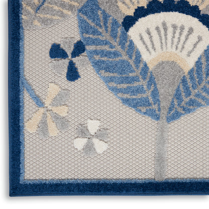 Woven decorative runner with navy blue border and light blue floral pattern on beige background.