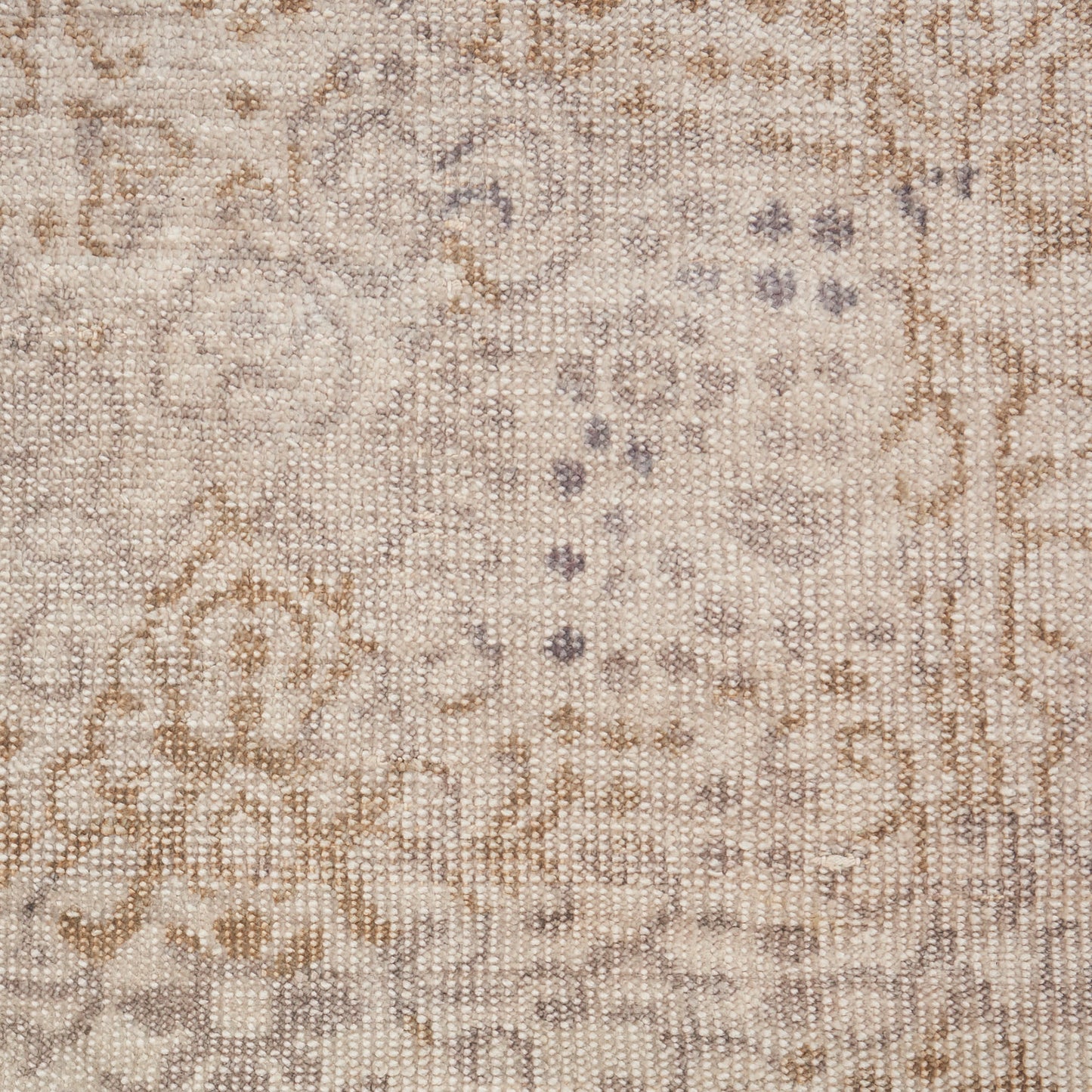 Beige oriental rug with ivory and taupe floral motifs, subtle blue accents, woven texture.