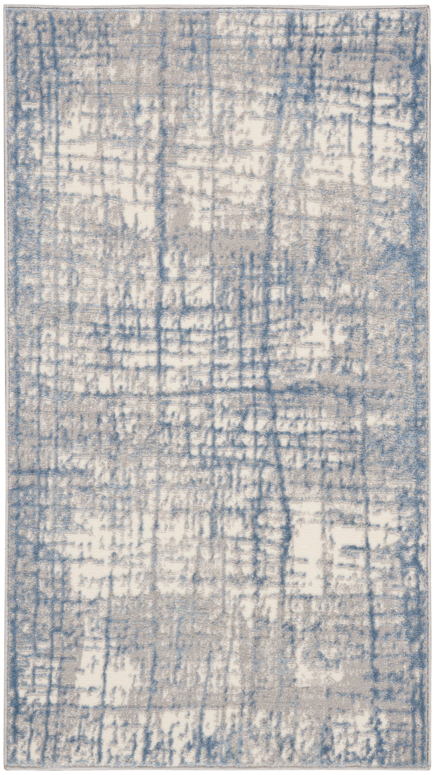 Blue and cream distressed abstract area rug with gray undertones; rectangular, modern pattern.