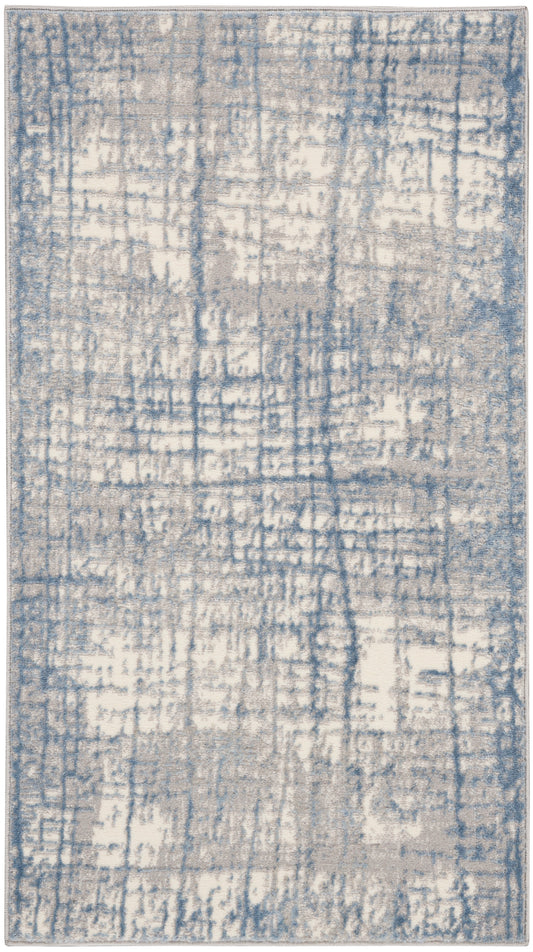 Blue and cream distressed abstract area rug with gray undertones; rectangular, modern pattern.
