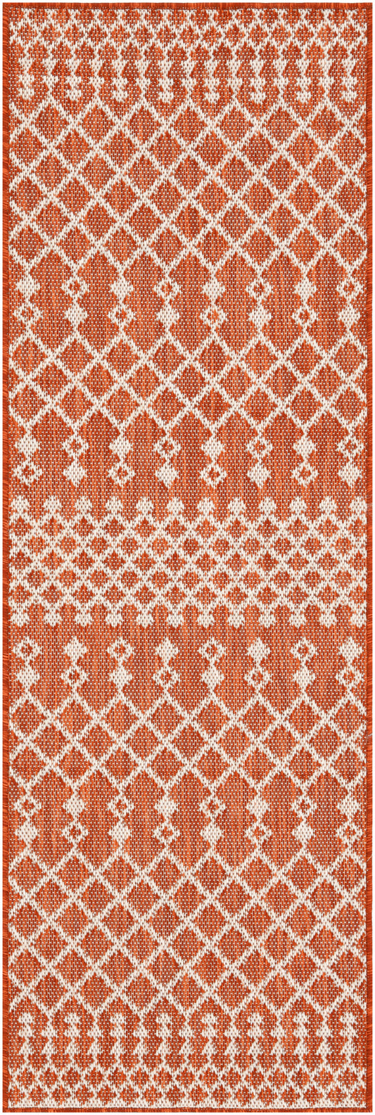 Long rust-orange and white woven rug runner with a repeating diamond lattice pattern and fringe ends.