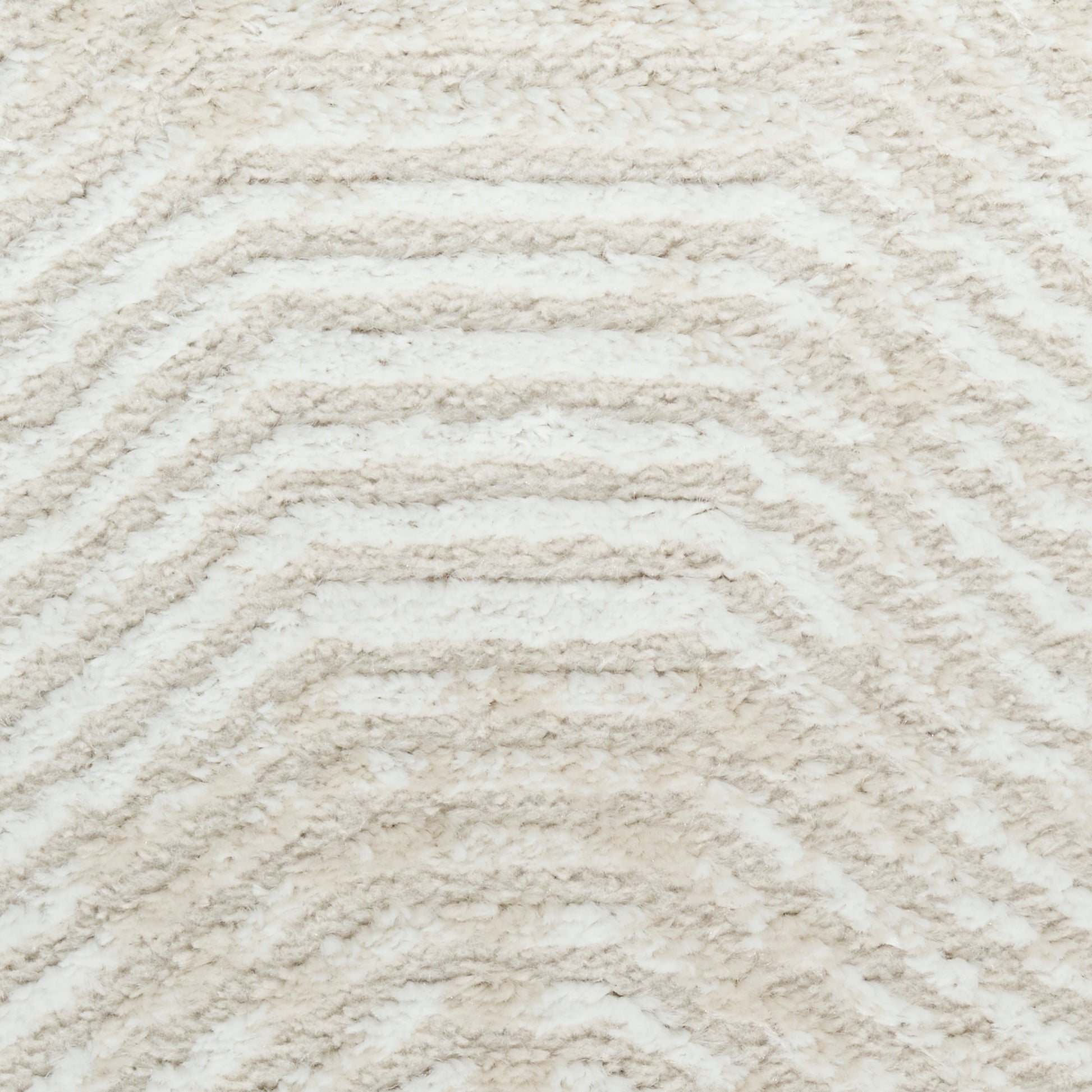 Cream beige shag rug with raised chevron pattern & plush tufted pile for cozy indoor decor.