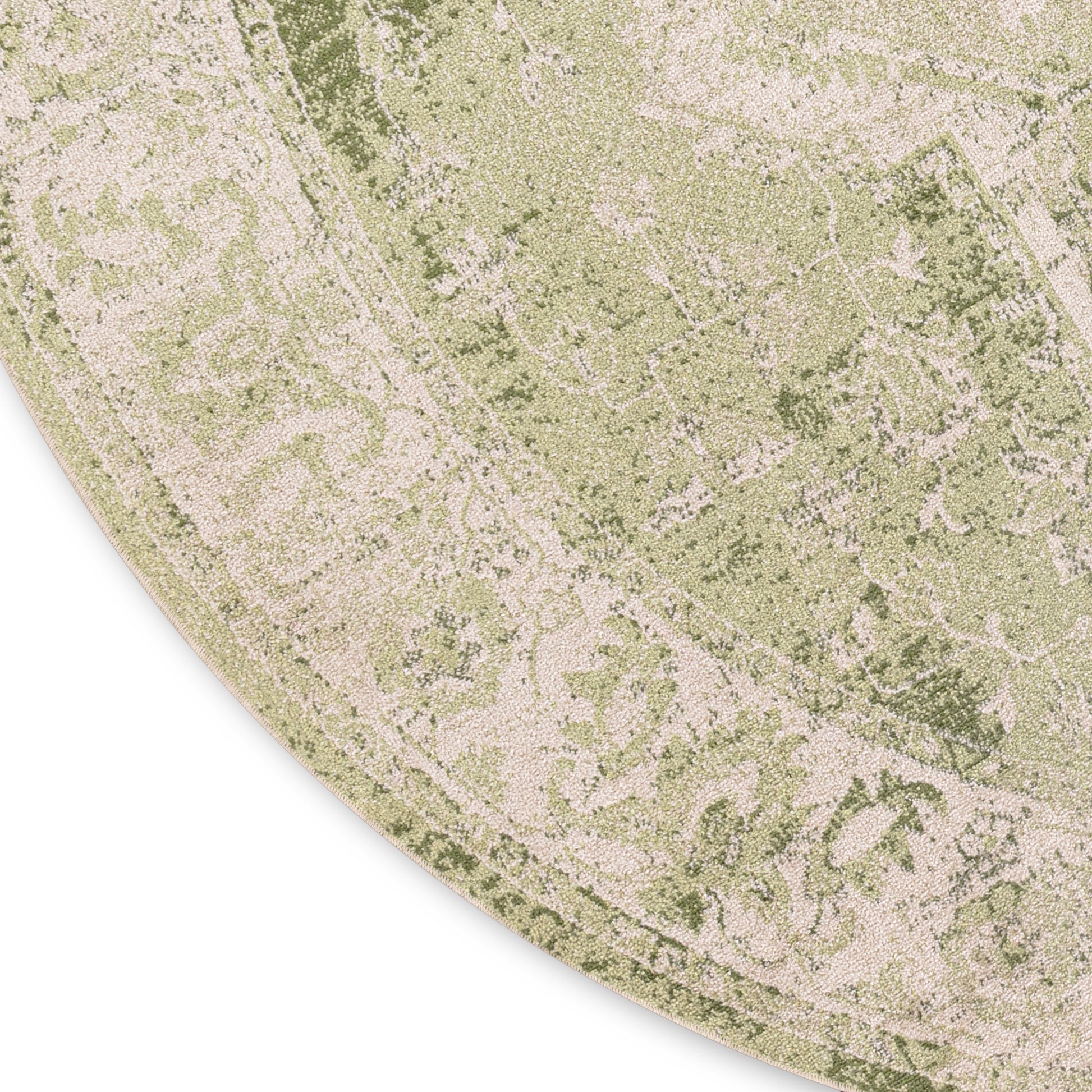 Round sage-green rug with antique floral motif in muted olive and beige tones, distressed vintage style.
