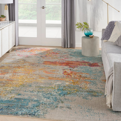 Abstract multicolor area rug featuring blues, teals, oranges and yellows in a modern living room.