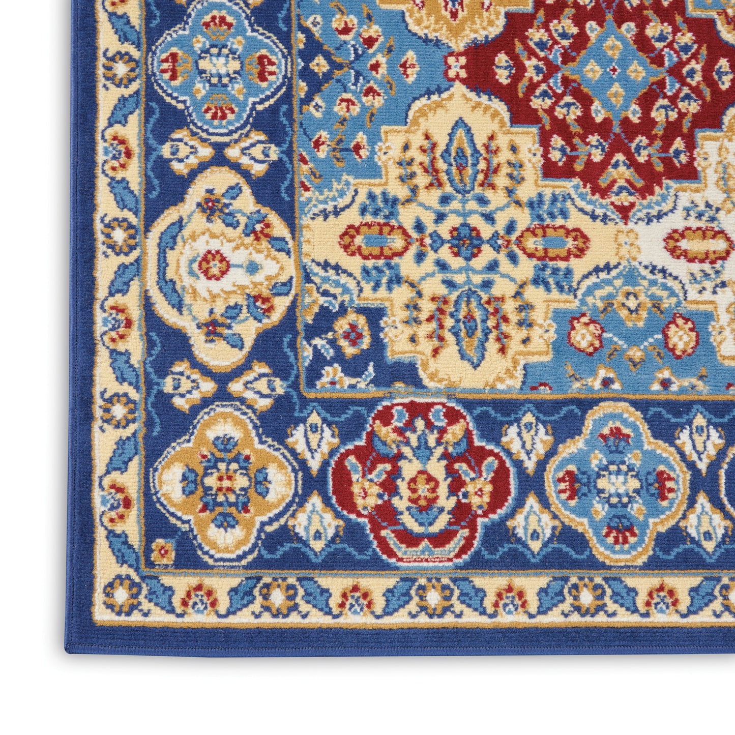 Close-up of a Bohemian rug with a blue border and ivory, gold, and red floral motifs.