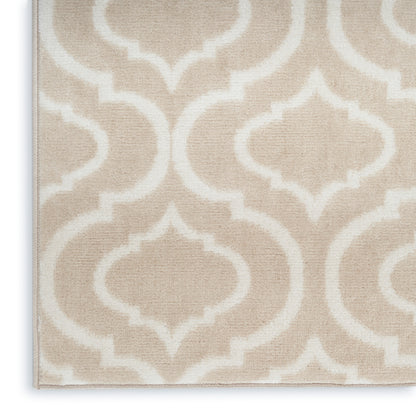 Beige woven rug with a white geometric trellis pattern; soft neutral decor for living spaces.