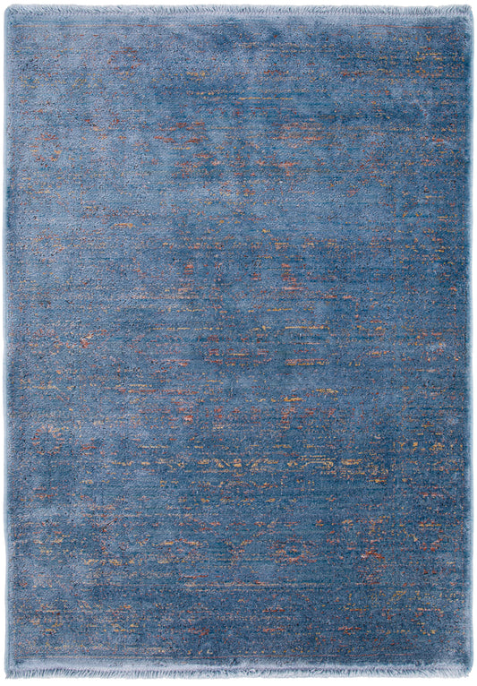 Blue distressed abstract rug with copper specks, plush pile and fringe border.