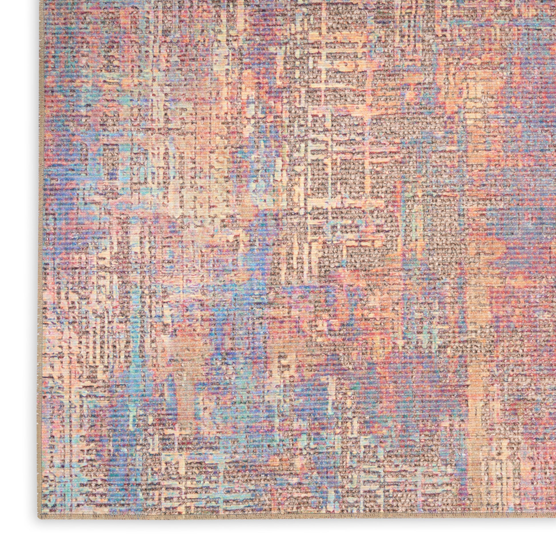 Abstract pastel area rug with peach, blue, lavender and cream tones in a distressed geometric pattern.
