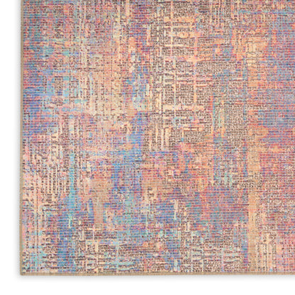 Abstract pastel area rug with peach, blue, lavender and cream tones in a distressed geometric pattern.