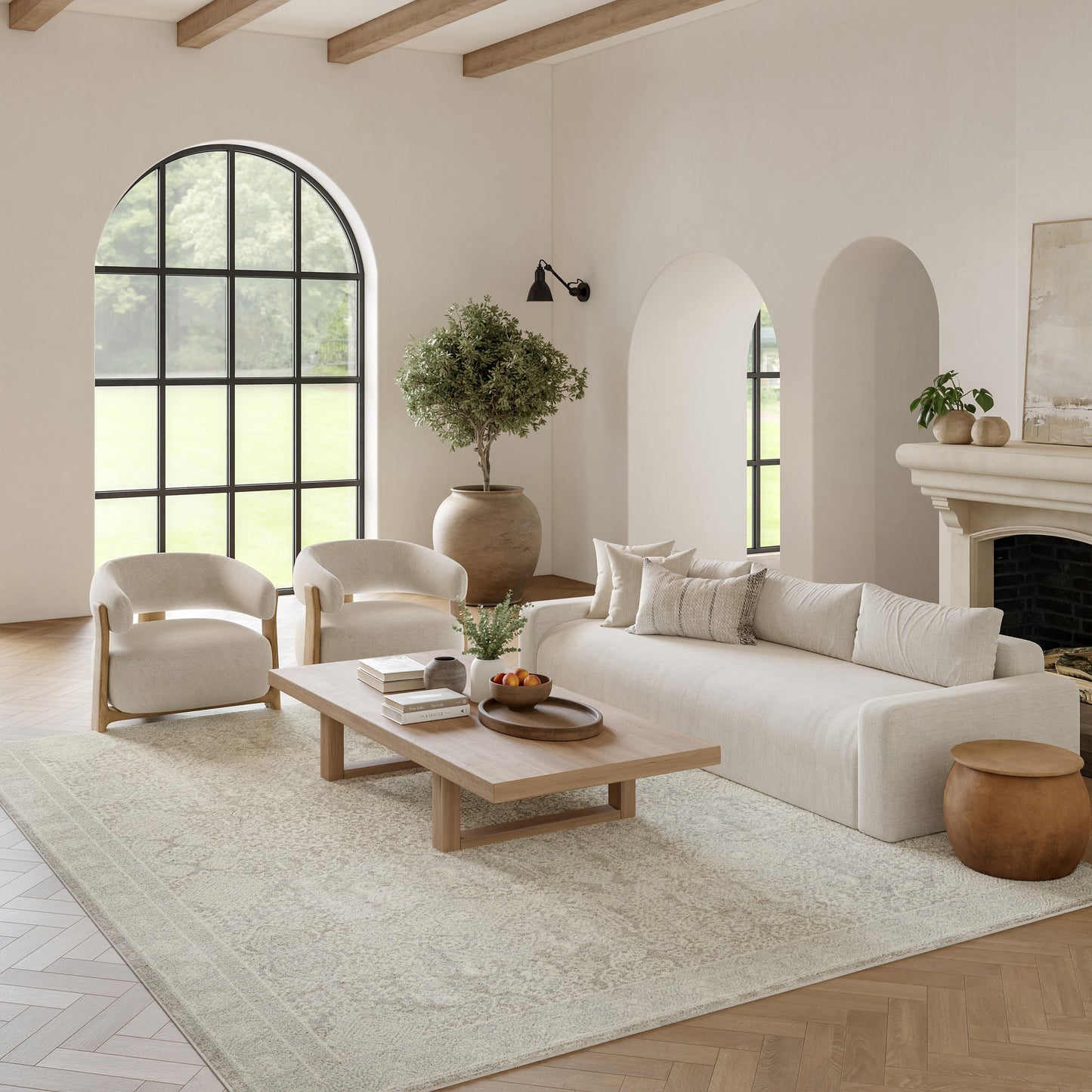 Neutral living room with beige sofa, cream chairs, wooden coffee table, arched window, light rug.